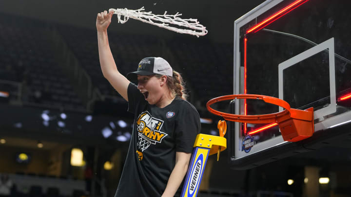 Former Iowa Hawkeyes guard Kate Martin (20) cuts the net 