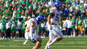 Boise State linebackers Marco Notarainni (53) and Boen Phelps celebrate a fourth-down stop.