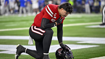 Texas Tech Red Raiders linebacker Jacob Rodriguez (10) kneels on the field before the game between the Red Raiders and the Cougars at AT&T Stadium.