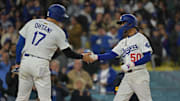Apr 1, 2025; Los Angeles, California, USA;  Los Angeles Dodgers two-way player Shohei Ohtani (17) high-fives shortstop Mookie Betts (50) after Betts hit a two run home run during the sixth inning against the Atlanta Braves at Dodger Stadium. 