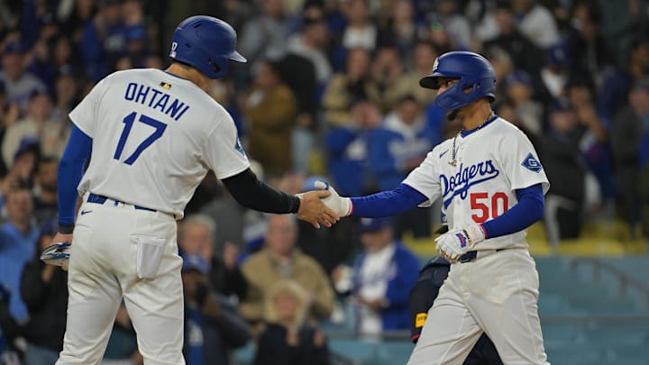 Apr 1, 2025; Los Angeles, California, USA;  Los Angeles Dodgers two-way player Shohei Ohtani (17) high-fives shortstop Mookie Betts (50) after Betts hit a two run home run during the sixth inning against the Atlanta Braves at Dodger Stadium. 