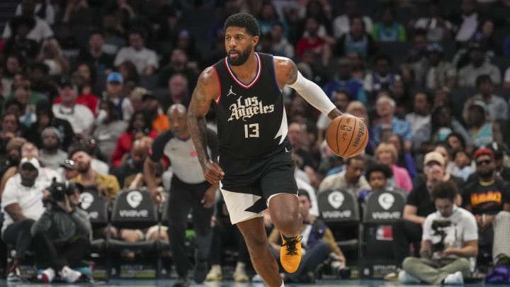 Mar 31, 2024; Charlotte, North Carolina, USA; LA Clippers forward Paul George (13) brings the ball up court against the Charlotte Hornets during the second half at Spectrum Center. Mandatory Credit: Jim Dedmon-USA TODAY Sports