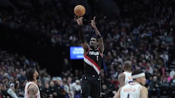 Feb 1, 2025; Portland, Oregon, USA; Portland Trail Blazers center Deandre Ayton (2, left) shoots the ball over Phoenix Suns center Nick Richards (2)  during the second half at Moda Center. Mandatory Credit: Soobum Im-Imagn Images
