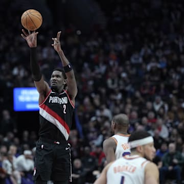 Feb 1, 2025; Portland, Oregon, USA; Portland Trail Blazers center Deandre Ayton (2, left) shoots the ball over Phoenix Suns center Nick Richards (2)  during the second half at Moda Center. Mandatory Credit: Soobum Im-Imagn Images