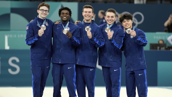 Jul 29, 2024; Paris, France; (From left to right) Stephen Nedoroscik, Frederick Richard, Brody Malone, Paul Juda, and Asher Hong hold their bronze medals after the men’s team final during the Paris 2024 Olympic Summer Games at Bercy Arena. Mandatory Credit: Kyle Terada-USA TODAY Sports