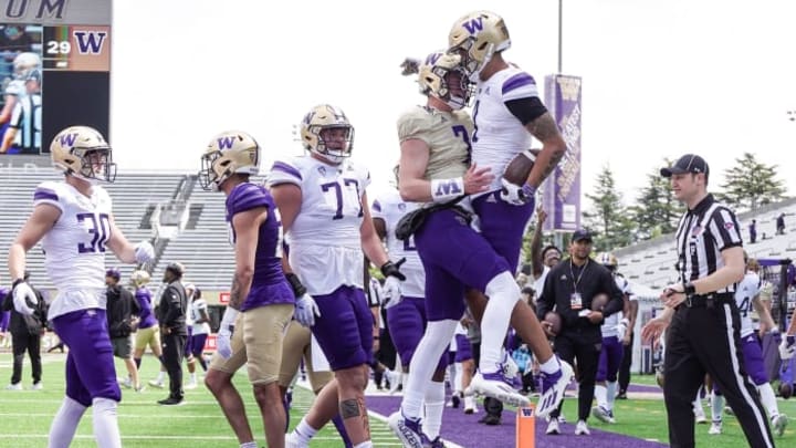 Lonyatta Alexander Jr., right, celebrates with Sam Huard during 2022 UW spring football. 