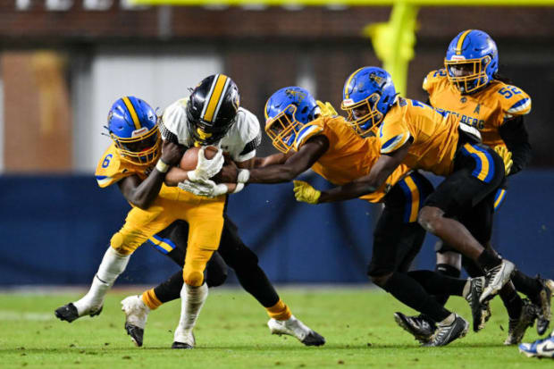 The Heidelberg Oiler defense swarms a Charleston runner during the 2023 MHSAA Class 2A State Championship in Oxford, Miss.