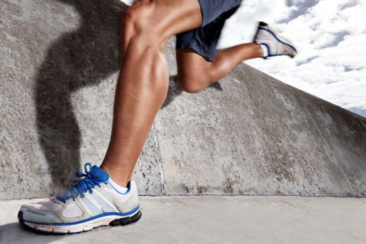 Legs of a runner with muscular calves