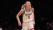 Dec 7, 2024; Brooklyn, New York, USA; Connecticut Huskies guard Paige Bueckers (5) reacts after missing a shot during the first half against the Louisville Cardinals at Barclays Center. Mandatory Credit: Lucas Boland-Imagn Images