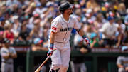 Cal Raleigh watches a home run leave the ballpark against the Pirates.