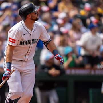 Cal Raleigh watches a home run leave the ballpark against the Pirates.