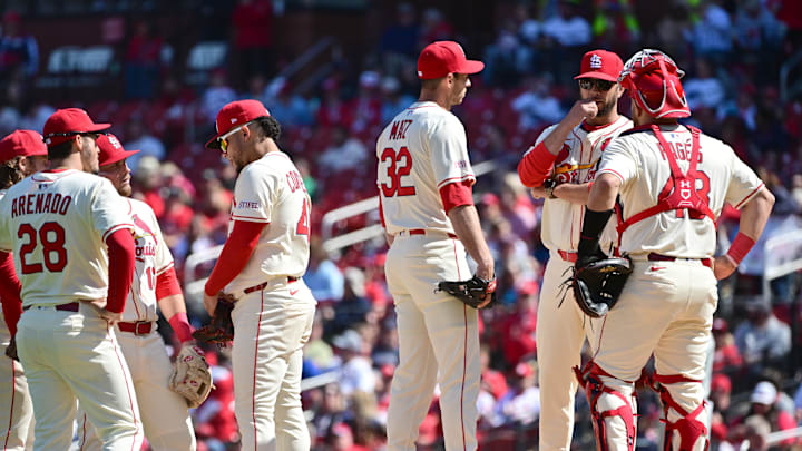 Apr 12, 2025; St. Louis, Missouri, USA; St. Louis Cardinals pitching coach Dusty Blake (90, second from right) talks over the situation with St. Louis Cardinals pitcher Steven Matz (32, left) and St. Louis Cardinals catcher Pedro Pages (43, right) in the sixth inning in a game against the Philadelphia Phillies at Busch Stadium, as the Cardiinals infield chats at left. Mandatory Credit: Tim Vizer-Imagn Images