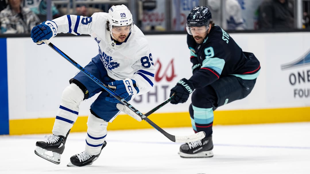 Feb 6, 2025; Seattle, Washington, USA;  Toronto Maple Leafs forward Nicholas Robertson (89) skates against Seattle Kraken forward Chandler Stephenson (9) during the second periodat Climate Pledge Arena. Mandatory Credit: Stephen Brashear-Imagn Images