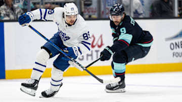 Feb 6, 2025; Seattle, Washington, USA;  Toronto Maple Leafs forward Nicholas Robertson (89) skates against Seattle Kraken forward Chandler Stephenson (9) during the second periodat Climate Pledge Arena. Mandatory Credit: Stephen Brashear-Imagn Images