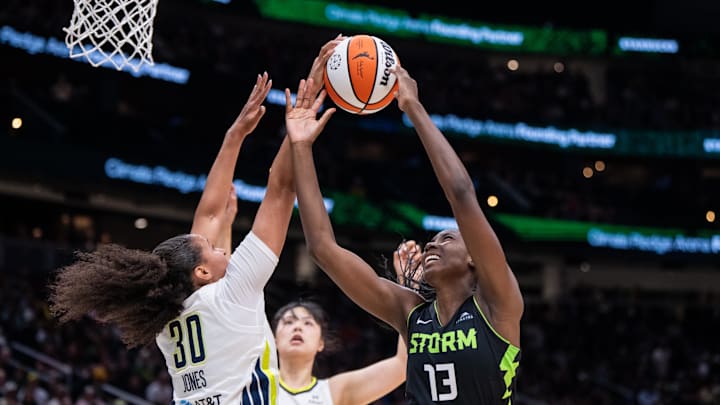 Jul 22, 2025; Seattle, Washington, USA;  Dallas Wings guard Haley Jones (30) blocks a shot by Seattle Storm forward Ezi Magbegor (13) during the first half at Climate Pledge Arena. 