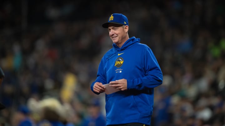 Seattle Mariners manager Dan Wilson meets with umps at home plate before a game against the San Francisco Giants on Friday at T-Mobile Park.