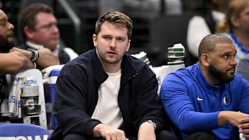 Jan 12, 2025; Dallas, Texas, USA; Dallas Mavericks guard Luka Doncic (77) reacts from the team bench during the second half of the game against the Denver Nuggets at the American Airlines Center. Mandatory Credit: Jerome Miron-Imagn Images