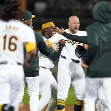 Sep 6, 2024; Oakland, California, USA; Oakland Athletics left fielder Seth Brown (center) celebrates with teammates after hitting a walk-off single against the Detroit Tigers during the 13th inning at Oakland-Alameda County Coliseum.