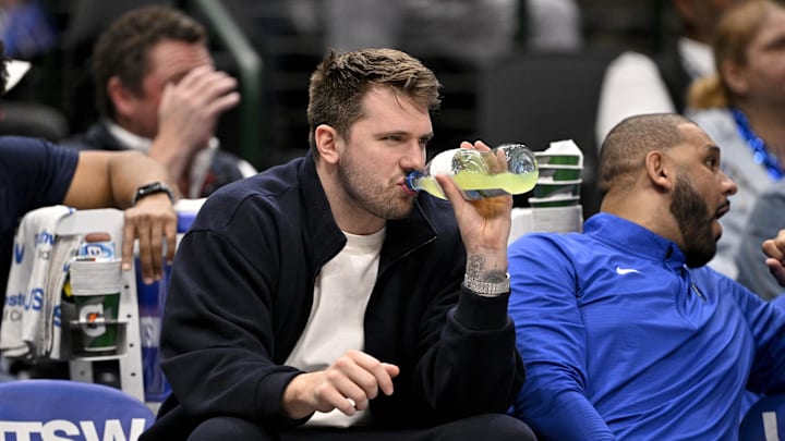 Jan 12, 2025; Dallas, Texas, USA; Dallas Mavericks guard Luka Doncic (77) watches from the team bench during the second half of the game against the Denver Nuggets at the American Airlines Center. 