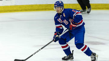 Aug 3, 2024; Plymouth, MI, USA; USA’s defenceman Aram Minnetian (17) skates up ice with the puck against Canada during the first period of the 2024 World Junior Summer Showcase at USA Hockey Arena. Mandatory Credit: David Reginek-Imagn Images