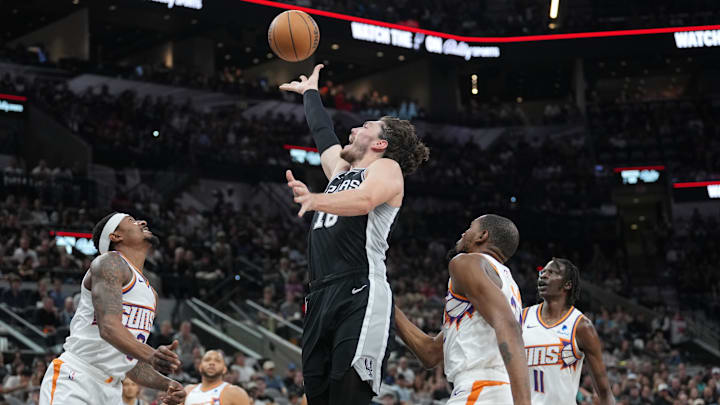 Mar 23, 2024; San Antonio, Texas, USA;  San Antonio Spurs forward Cedi Osman (16) shoots over Phoenix Suns guard Bradley Beal (3) in the first half at Frost Bank Center. Mandatory Credit: Daniel Dunn-Imagn Images