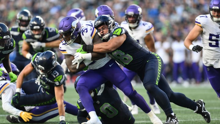 Aug 10, 2023; Seattle, Washington, USA; Seattle Seahawks linebacker Levi Bell (98) tackles Minnesota Vikings running back DeWayne McBride (37) during the first half at Lumen Field. Mandatory Credit: Steven Bisig-USA TODAY Sports