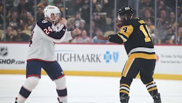 Mar 21, 2025; Pittsburgh, Pennsylvania, USA;  Pittsburgh Penguins left wing Bokondji Imama (14) and Columbus Blue Jackets right wing Mathieu Olivier (24) fight during the first period at PPG Paints Arena. Mandatory Credit: Charles LeClaire-Imagn Images