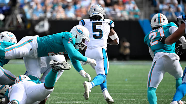 Carolina Panthers running back Rico Dowdle (5) runs as Miami Dolphins outside linebacker Bradley Chubb (2) and safety Ashtyn Davis (21) defend in the fourth quarter at Bank of America Stadium.