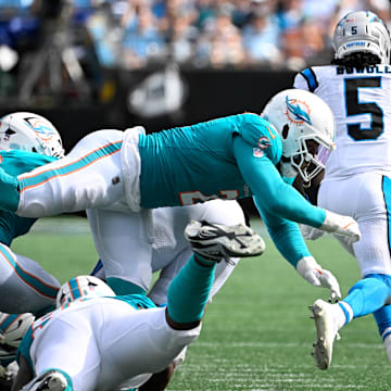 Carolina Panthers running back Rico Dowdle (5) runs as Miami Dolphins outside linebacker Bradley Chubb (2) and safety Ashtyn Davis (21) defend in the fourth quarter at Bank of America Stadium.