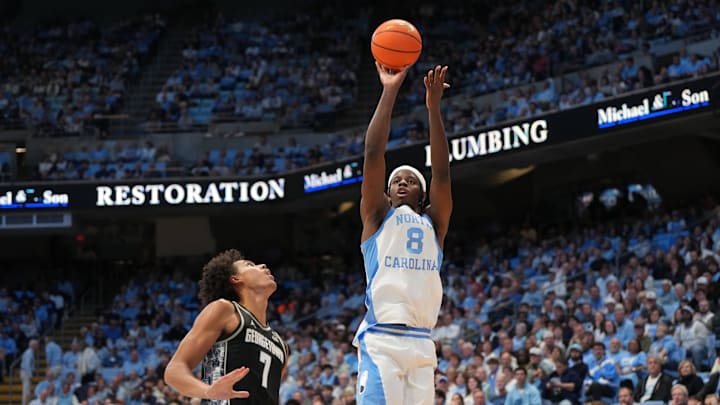 Dec 7, 2025; Chapel Hill, North Carolina, USA;  North Carolina Tar Heels forward Caleb Wilson (8) shoots as Georgetown Hoyas forward Isaiah Abraham (7) defends in the second half at Dean E. Smith Center. Mandatory Credit: Bob Donnan-Imagn Images