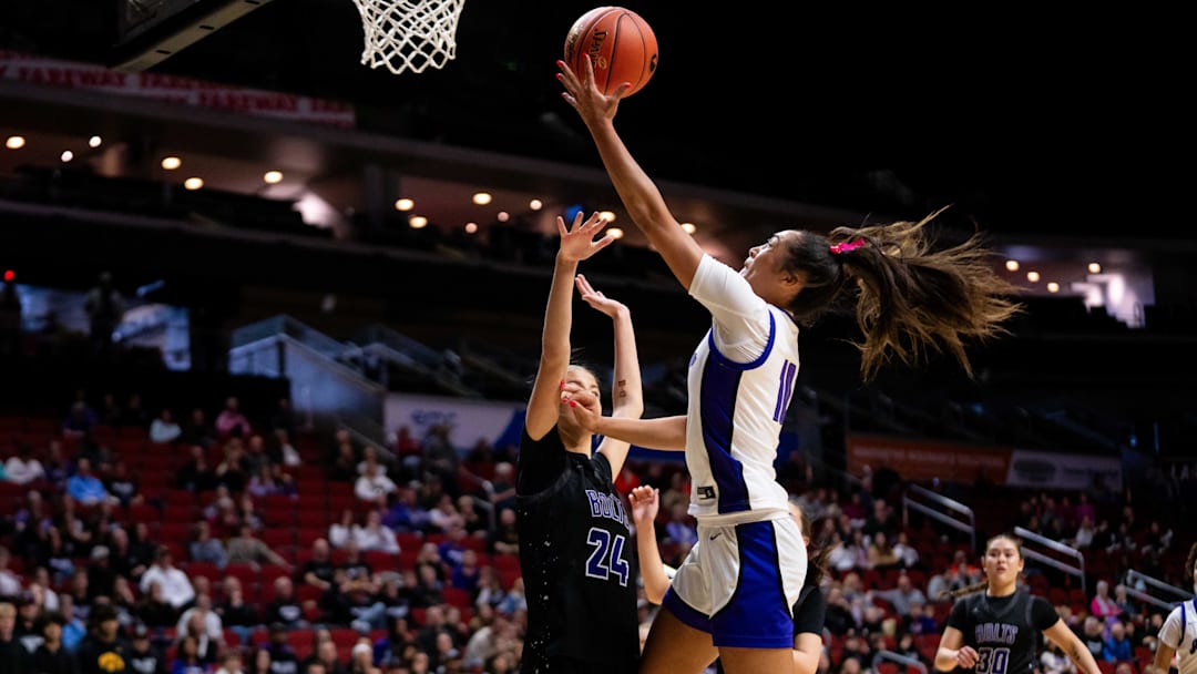 Johnston's Jenica Lewis (10) drives to the basket against Iowa City Liberty's Madilyn Meyer (24) on Monday, March 3, 2025, at Wells Fargo Arena.