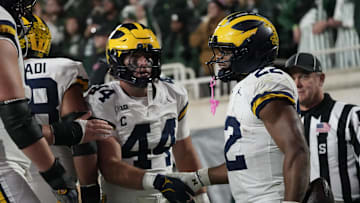 Oct 25, 2025; East Lansing, Michigan, USA; Michigan Wolverines running back Justice Haynes (22) reacts with tight end Max Bredeson (44) after scoring a touchdown against the Michigan Wolverines during the second half at Spartan Stadium. Mandatory Credit: Brendan Mullin-Imagn Images