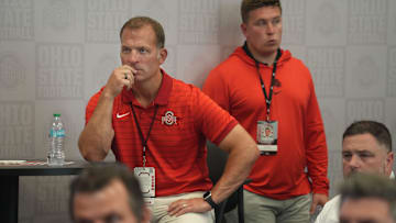 Ohio State University Athletic Director Ross Bjork listens to coach Ryan Day during the post-game news conference after the Texas at Ohio State football game at Ohio Stadium in Columbus on Saturday, Aug. 30, 2025.