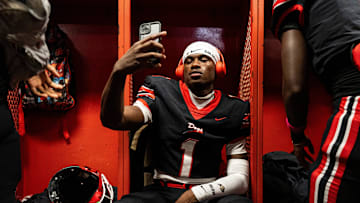 Brandon wide receiver Preston Ashley (1) looks at his phone before a high school football game between Petal and Brandon at Bulldog Stadium in Brandon, Miss., on Friday, Oct. 17, 2025. Petal defeated Brandon 27-21.