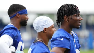 Jul 25, 2024; East Rutherford, NY, USA; New York Giants wide receiver Malik Nabers (right) watches a drill with wide receiver Wan'Dale Robinson (middle) and wide receiver Darius Slayton (left) during training camp at Quest Diagnostics Training Center.  