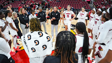 Louisville Cardinals head coach Jeff Walz talks to the Cards after their win over Southern Indiana University Friday night at the KFC Yum! Center in Louisville, Ky. Nov. 8, 2024.