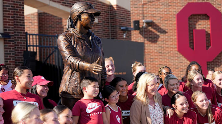 Oklahoma head coach Patty Gasso take a picture with players and family during a statue dedication at Love's Field in Norman, Okla,, Friday, Sept., 13, 2024.