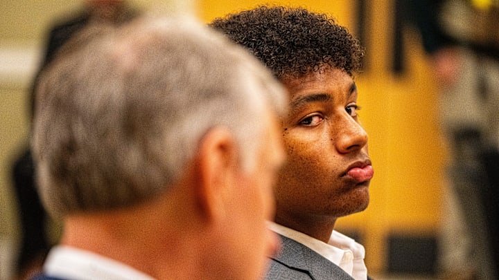 Ole Miss quarterback Trinidad Chambliss glances over toward members of the press during the hearing of his lawsuit against the NCAA at Calhoun County Courthouse in Pittsboro, Miss.