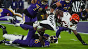 Bengals Joseph Ossai (58) helps take down Ravens Lamar Jackson (8) for Bengals Cedric Johnson (52) to gain possession of the ball during their game against the Ravens at M&T Bank Stadium on Thanksgiving Thursday November 27, 2025.
