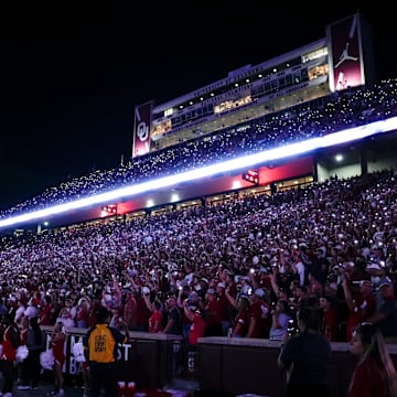 Fans hold up their phones to light up the stadium during a college football game between the University of Oklahoma Sooners (OU) and the Houston Cougars at Gaylord Family – Oklahoma Memorial Stadium in Norman, Okla., Saturday, Sept. 7, 2024.