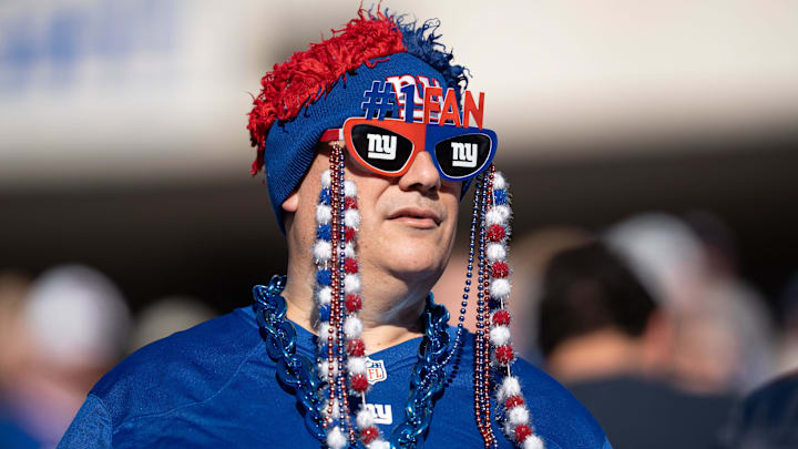 New York Giants fan cheers on his team during a game between the New York Giants and the Washington Commanders. New York Giants fan cheers on his team during a game between the New York Giants and the Washington Commanders.