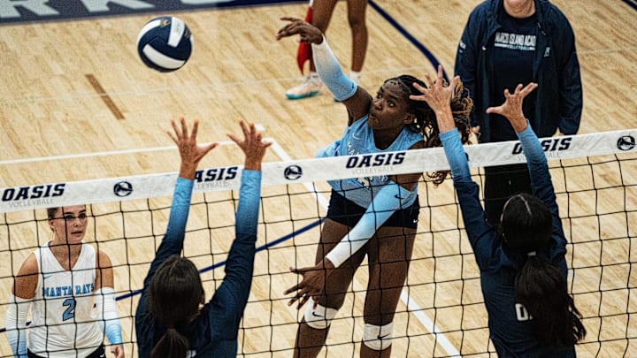 Medney Garraux of Marco Island spikes against Oasis. Medney Garraux of Marco Island spikes against Oasis.