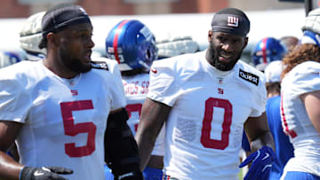 Jul 26, 2024; East Rutherford, NJ, USA; New York Giants linebacker Kayvon Thibodeaux (5) and New York Giants linebacker Brian Burns (0) break on the sideline during training camp at Quest Diagnostics Training Center. Mandatory Credit: Lucas Boland-Imagn Images