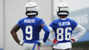 Jul 25, 2024; East Rutherford, NY, USA; New York Giants wide receiver Malik Nabers (9) and wide receiver Darius Slayton (86) look on during training camp at Quest Diagnostics Training Center.  