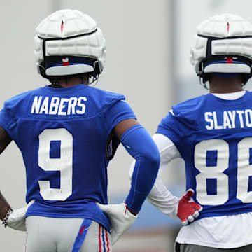 Jul 25, 2024; East Rutherford, NY, USA; New York Giants wide receiver Malik Nabers (9) and wide receiver Darius Slayton (86) look on during training camp at Quest Diagnostics Training Center.  