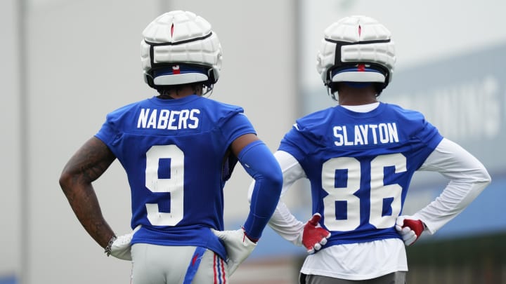 Jul 25, 2024; East Rutherford, NY, USA; New York Giants wide receiver Malik Nabers (9) and wide receiver Darius Slayton (86) look on during training camp at Quest Diagnostics Training Center.  