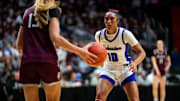 Johnston's Jenica Lewis (10) defends Dowling Catholic's Ava Zediker (13) as she walks the ball down the court on Friday, March 7, 2025, at Wells Fargo Arena.