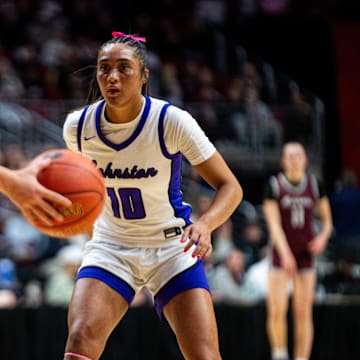 Johnston's Jenica Lewis (10) defends Dowling Catholic's Ava Zediker (13) as she walks the ball down the court on Friday, March 7, 2025, at Wells Fargo Arena.