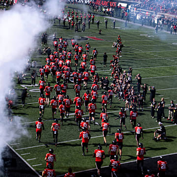 Cincinnati Bearcats run onto the field before the NCAA football game between the Cincinnati Bearcats and UCF Knights at Nippert Stadium in Cincinnati on Oct. 11, 2025.