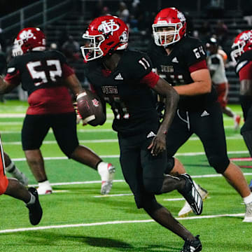 Vero Beach's Efrem White (11) runs the ball against Cocoa last Friday at the Citrus Bowl. White passed for two touchdowns and ran for another score to lead the Indians to a 38-3 victory.